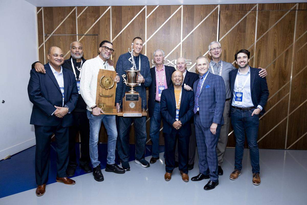 Kentucky’s 1983-84 basketball team, which advanced to the Final Four, was honored during a Wildcats game last season in Rupp Arena. From left: Paul Andrews, Winston Bennett, Kenny Walker, Sam Bowie, Jim Master, Leroy Byrd, assistant coach Jim Hatfield, Dr. Rob Davenport, Tom Heitz and Ben Bearup, son of the late Bret Bearup.