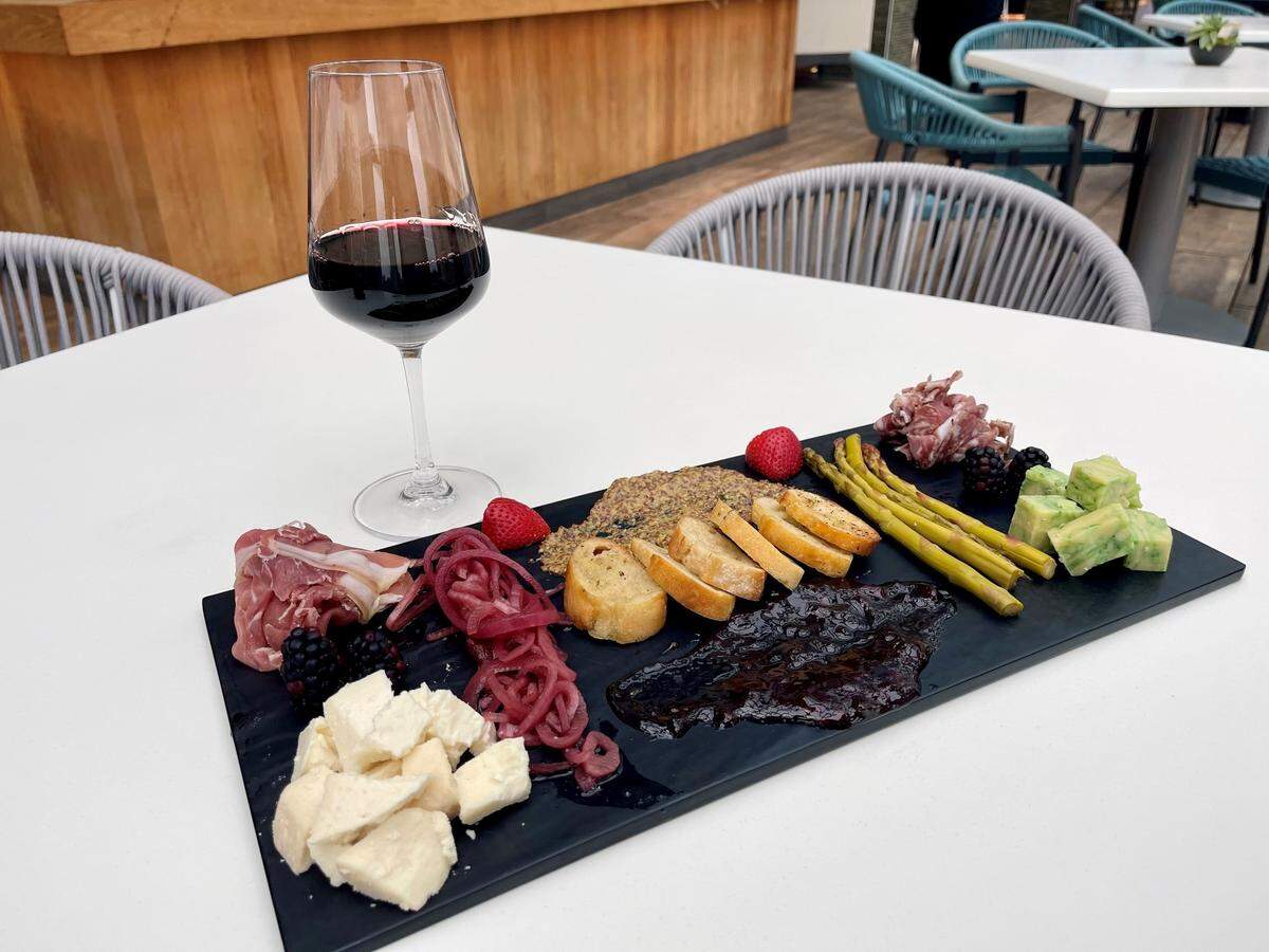 A charcuterie board with local cheeses, paired with wine, from the Infinity Sky Bar & Cafe.