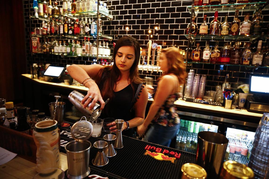 Alley McDowell, of Lexington, mixed drinks at the full bar Thursday at the Burl Arcade in Lexington.  The Burl Arcade offers a variety of retro games including Pac-Man, Galaga, skee ball and pinball.