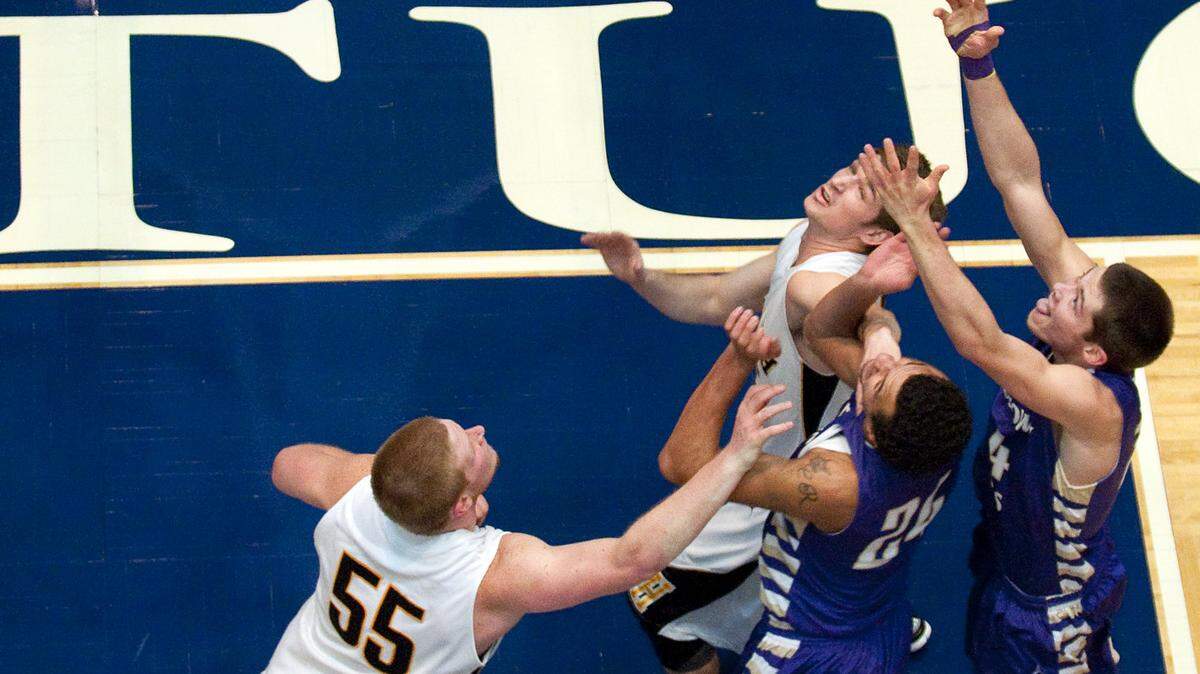 Heath's Jacob Jett, left, and Drew Winkle, fought for a rebound with Bardstown's Cody Ramos, center, and Justin Hubbard during the semifinal round of the All "A" Classic.        