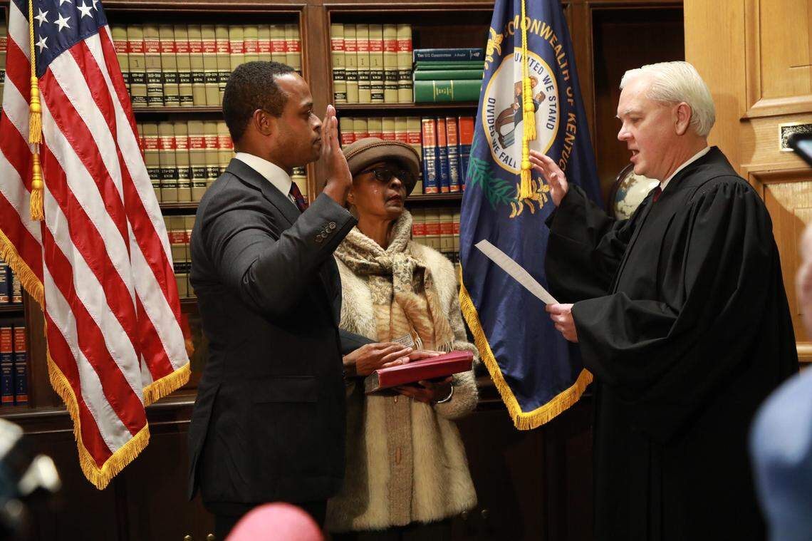 U.S. District Judge Gregory F. Tatenhove, right, swears in Daniel Cameron as Kentucky’s first black attorney general as his mother, Sandra Cameron, looks on. The ceremony was held on Dec. 17, 2019.