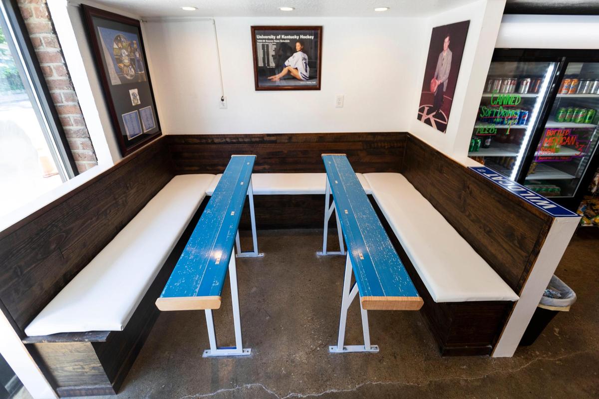 The Big Blue Deli is covered in University of Kentucky Wildcat memorabilia including two retired Rupp Arena benches as table tops on Limestone Street in Lexington, Ky., Friday, August 12, 2022.