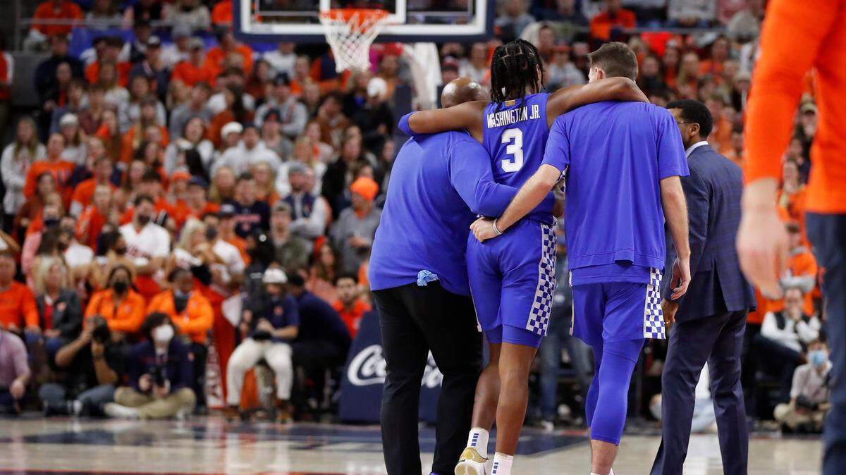 Kentucky Wildcats guard TyTy Washington Jr. (3) is escorted off the court with an injury during a game against the Auburn Tigers at Auburn Arena in Auburn, Ala., Saturday, Jan. 22, 2022.