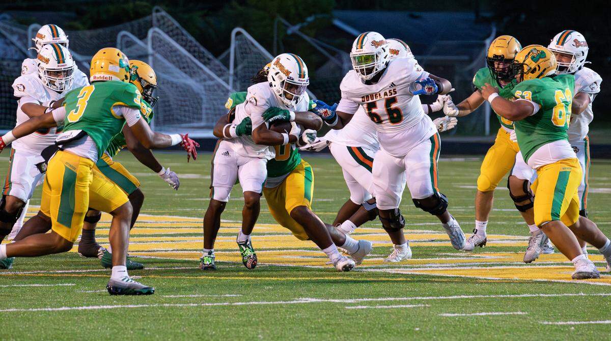 Bronco's RB Dakari Talbert (6) runs up the middle for yards gained during the Class 6A, 8th District battle between Frederick Douglass and host Bryan Station on Oct. 17, 2025, in Lexington, Ky.