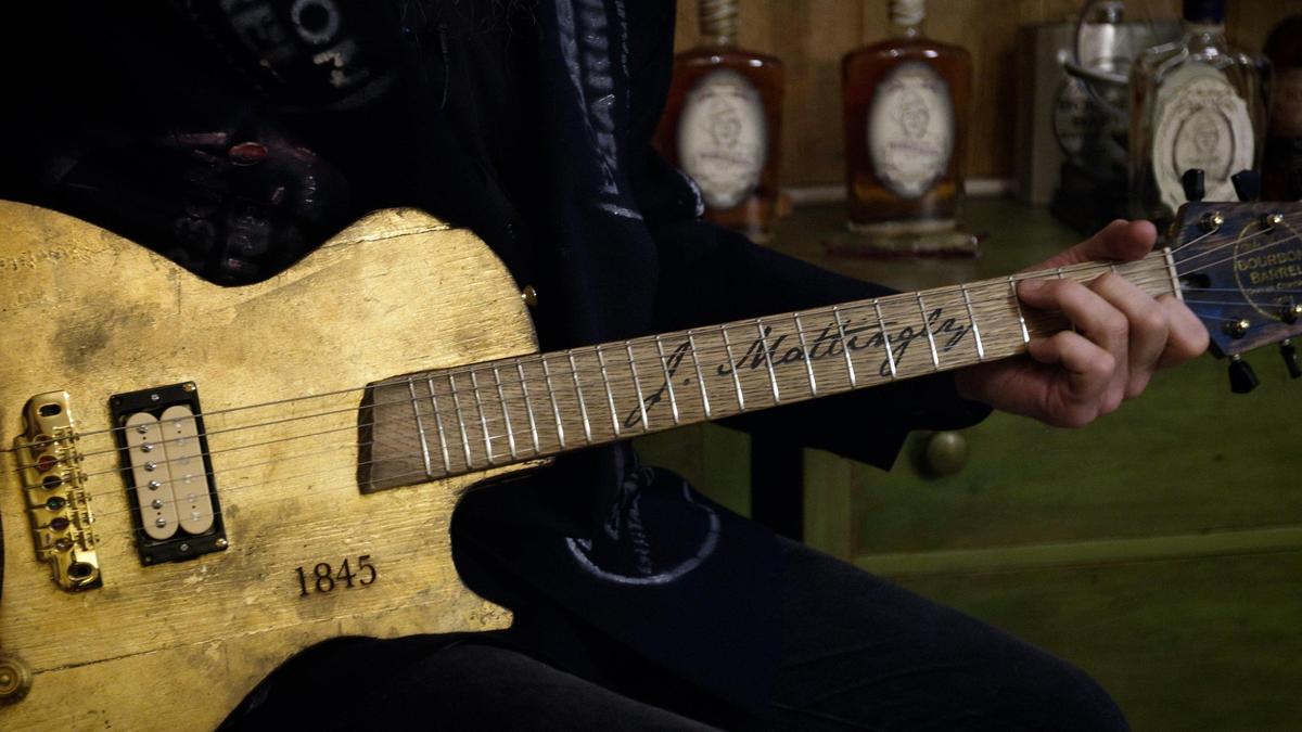 Mike Mankel, owner of Bourbon Barrel Guitars in Athens, plays a guitar he hand crafted into the style of J Mattingly 1845 bourbon, July 1, 2021. Mankel has partnered with Georgetown’s Bourbon 30 for the blending of J. Mattingly 1845 Noble Soul bourbon.