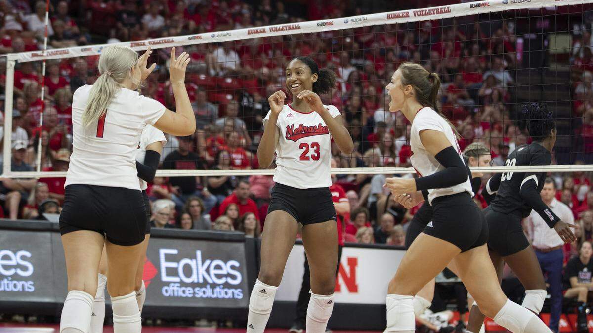 Kaitlyn Hord, center, celebrates with her Nebraska volleyball teammates during a victory over Loyola Marymount on Sept. 1.
