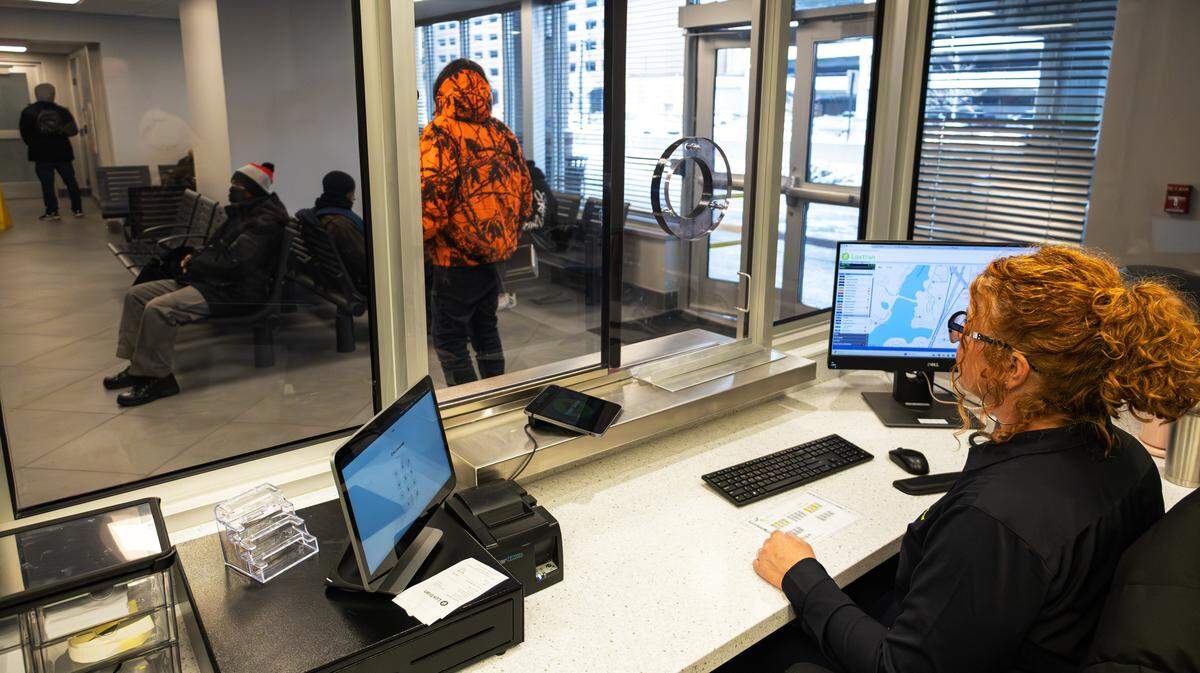 Customer service representative waits for the next LexTran customer to assist in sound-control booths at the newly renovated Transit Center in downtown Lexington, Ky, on Feb. 6, 2026.