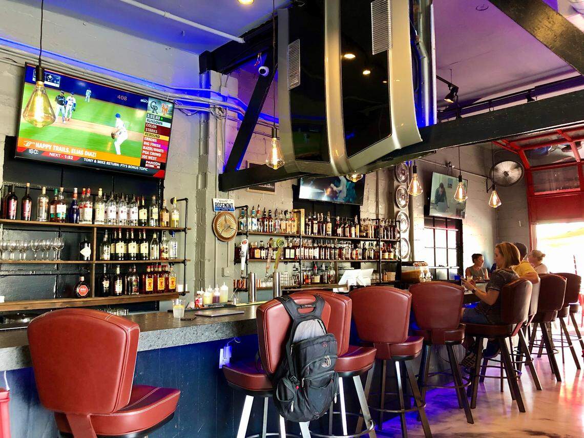 Car hoods are mounted above the bar at Rosemont Station.