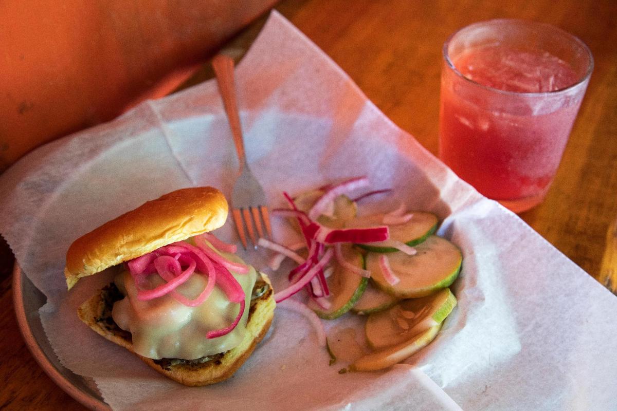 A sausage burger with cheese and pickled onions at Hop’s Beer Garden and Restaurant in Kentucky’s Red River Gorge. The menu options change seasonally with the availability of local ingredients.
