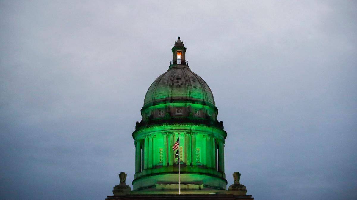 The Kentucky state Capitol Rotunda is illuminated in green to honor Kentuckians who have lost their lives to COVID-19 in Frankfort, Ky., Thursday, Dec. 3, 2020
