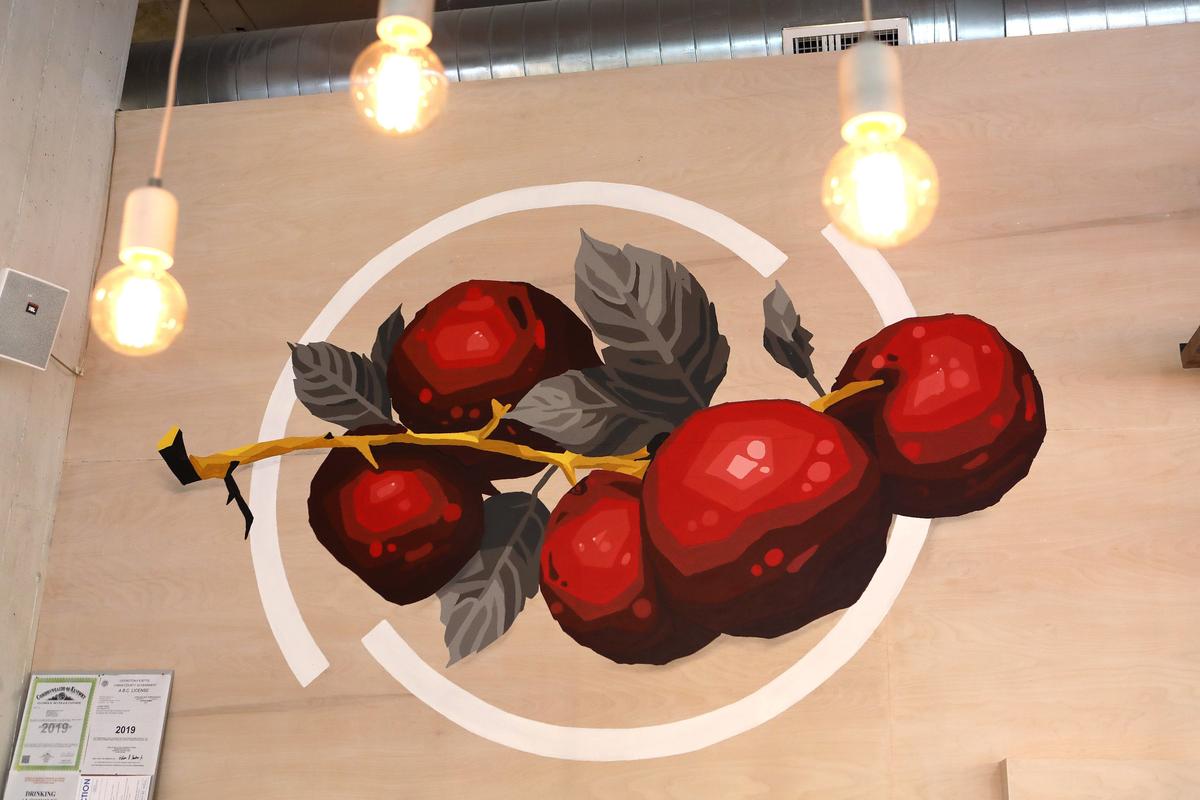 The mural of apples at Wise Bird Cider Co., which opens June 7 in the Pepper Distillery District, also was done by Often Seen Rarely Spoken, an artists’ group in Louisville.