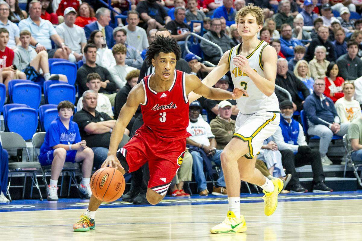 Great Crossing's Travanti Cooper (3) drives past St. X's Connor Klein (2) during the Cardinals 58-50 (OT) win over the Tigers in the finals of the 2026 UK HealthCare Boys' Basketball Sweet 16 state tournament, Saturday, March 21, 2026 at Rupp Arena in Lexington, Ky.