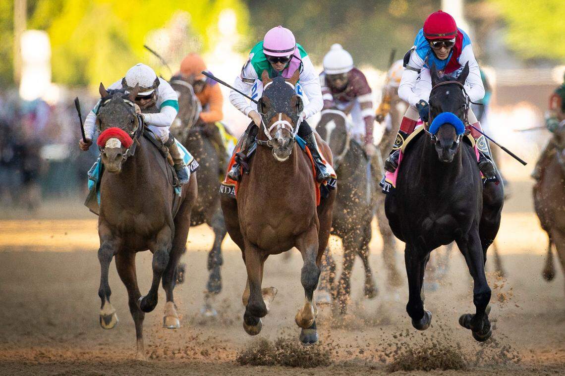Mandaloun with Florent Geroux up, center, crosses the finish line behind Medina Spirit, right, during the 147th Kentucky Derby at Churchill Downs in 2021. Medina Spirit was later disqualified based on a drug test, and Mandaloun was declared the winner.