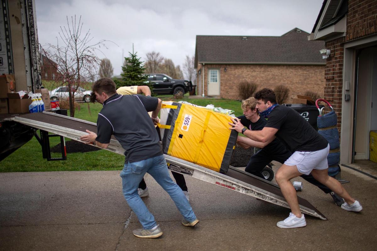 Volunteers load items donated by individuals through social media to Father Jim Sichko intended for flood relief help in Eastern Kentucky communities in outside Richmond, Ky., Thursday, March 25, 2021. Included in the donations were items like cleaning supplies, trash bags, food, socks, blankets, pillows and some gift cards.