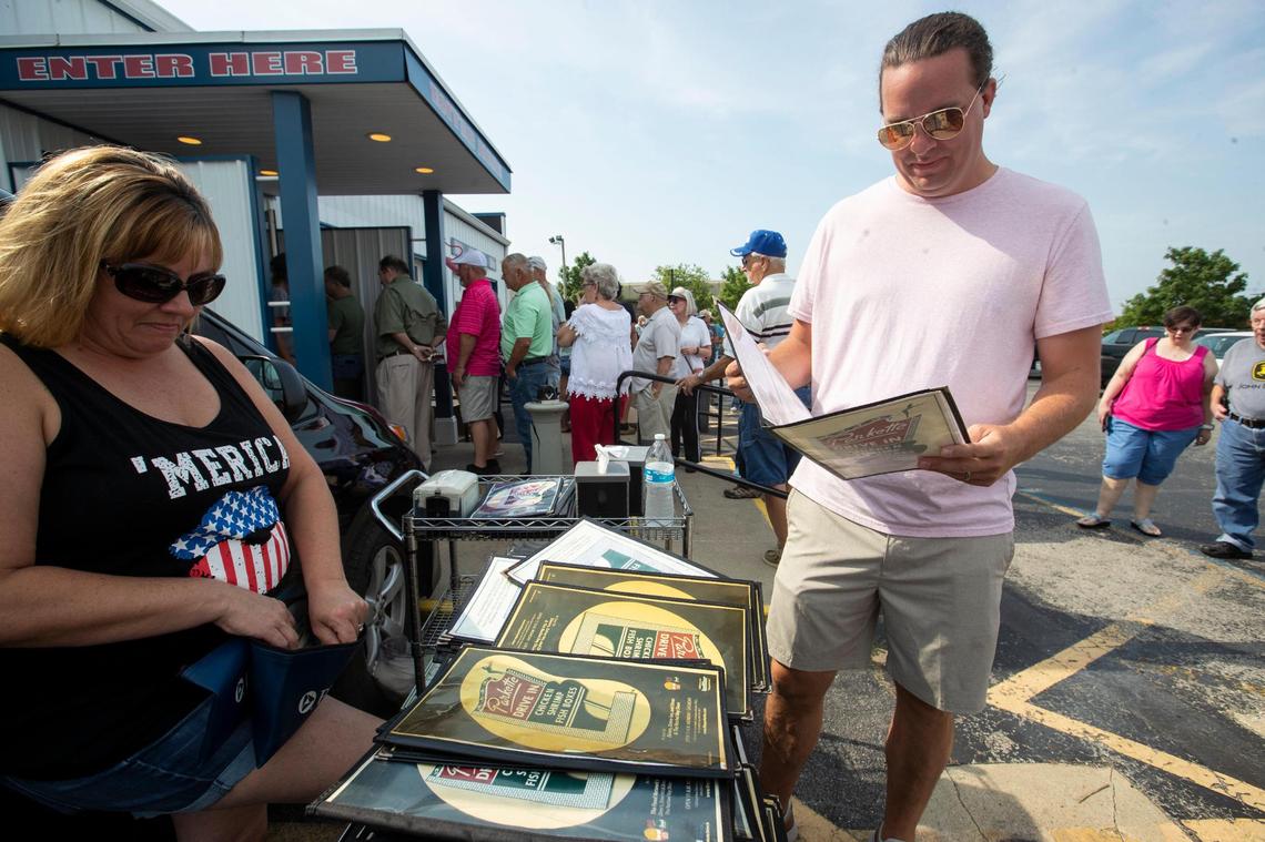 Michael Phelps buys a menu outside Parkette Drive-In during a sale in Lexington, Ky., Saturday, July 23, 2022.