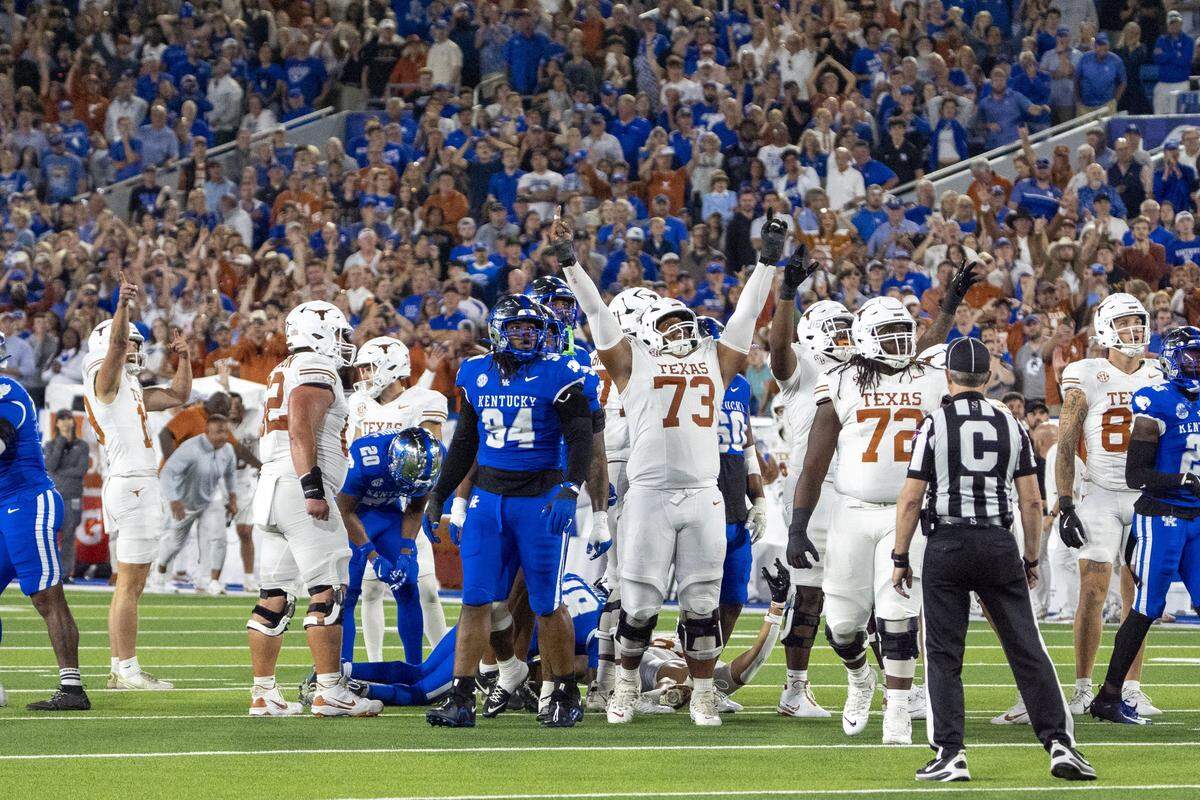 Texas players celebrate kicker Mason Shipley’s game-winning filed goal in overtime against Kentucky on Saturday night at Kroger Field.