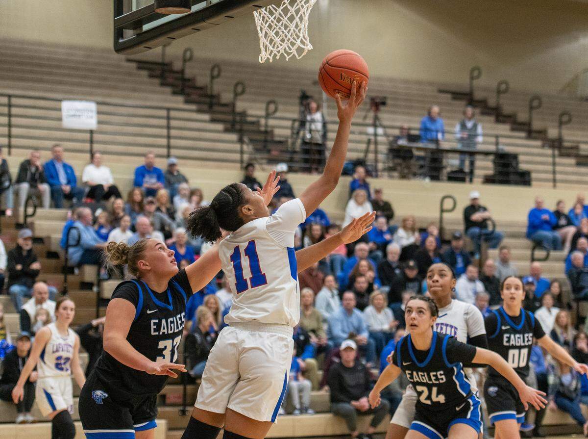 Lafayette’s Belle Combs (11) drives for a reverse layup on her way to earning tournament MVP honors Friday night.