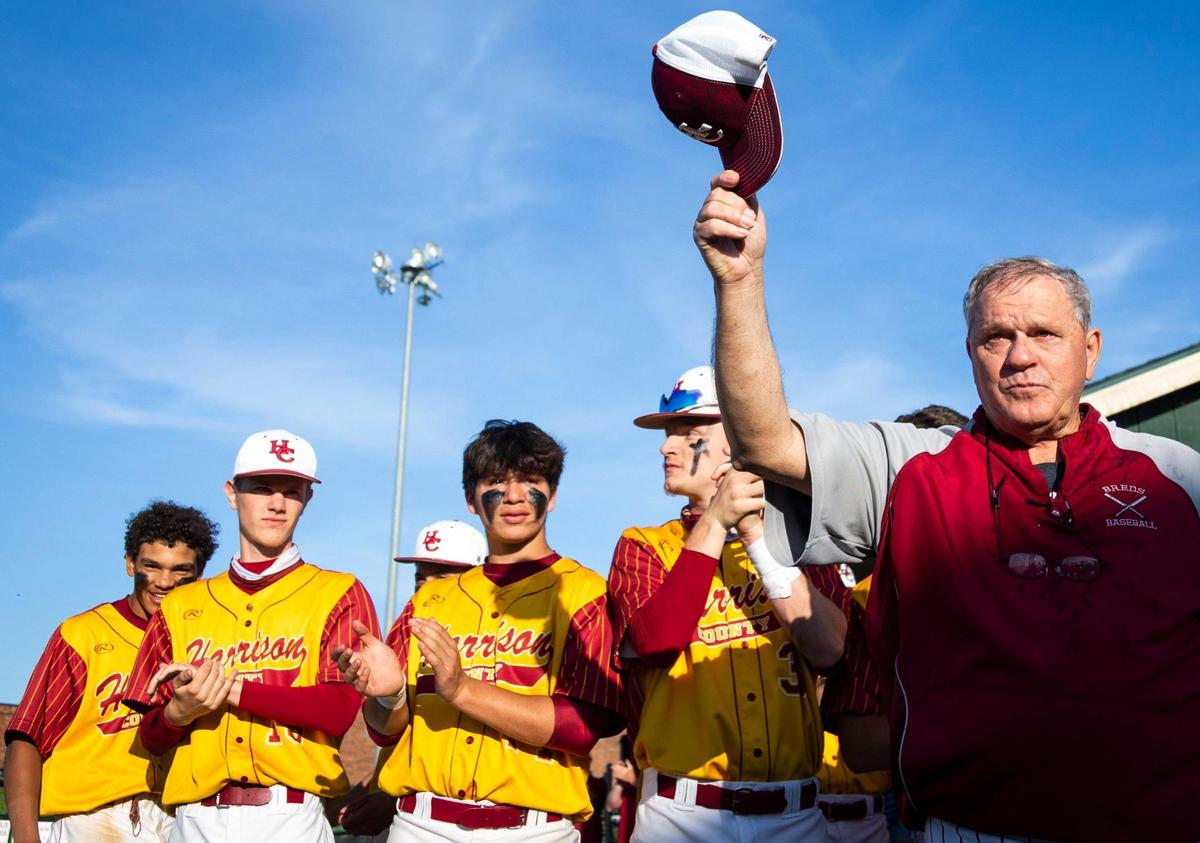 Harrison County High School baseball head coach Mac Whitaker tips his cap in thanks after his team helped him set Kentucky’s all-time wins record.