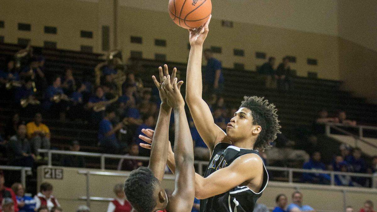 Henry Clay's Jordan Houston (44) shot in the lane over Dunbar's Dontell Brown (4), during the semifinals of the boys 11th Region tournament March 5, 2016, at EKU's McBrayer Arena in Richmond.  Houston drowned in a Tennessee lake Monday afternoon.