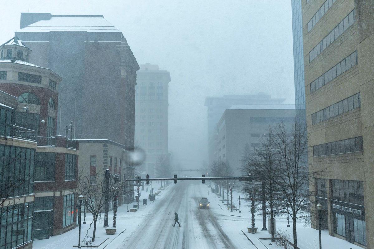 A person crosses Main Street in downtown Lexington, Ky., on Sunday, Jan. 5, 2025.