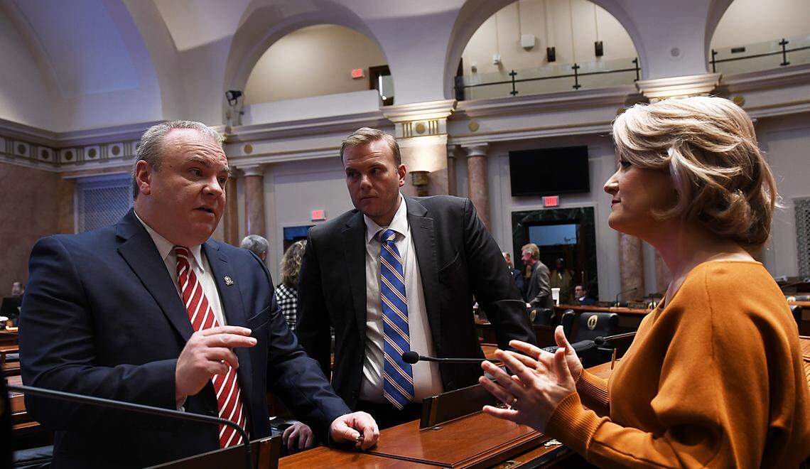 House Majority Whip Jason Nemes, R-Middletown, Rep. Steven Doan, R-Erlanger, and Rep. Savannah Maddox, R-Dry Ridge discuss a bill on the House floor.