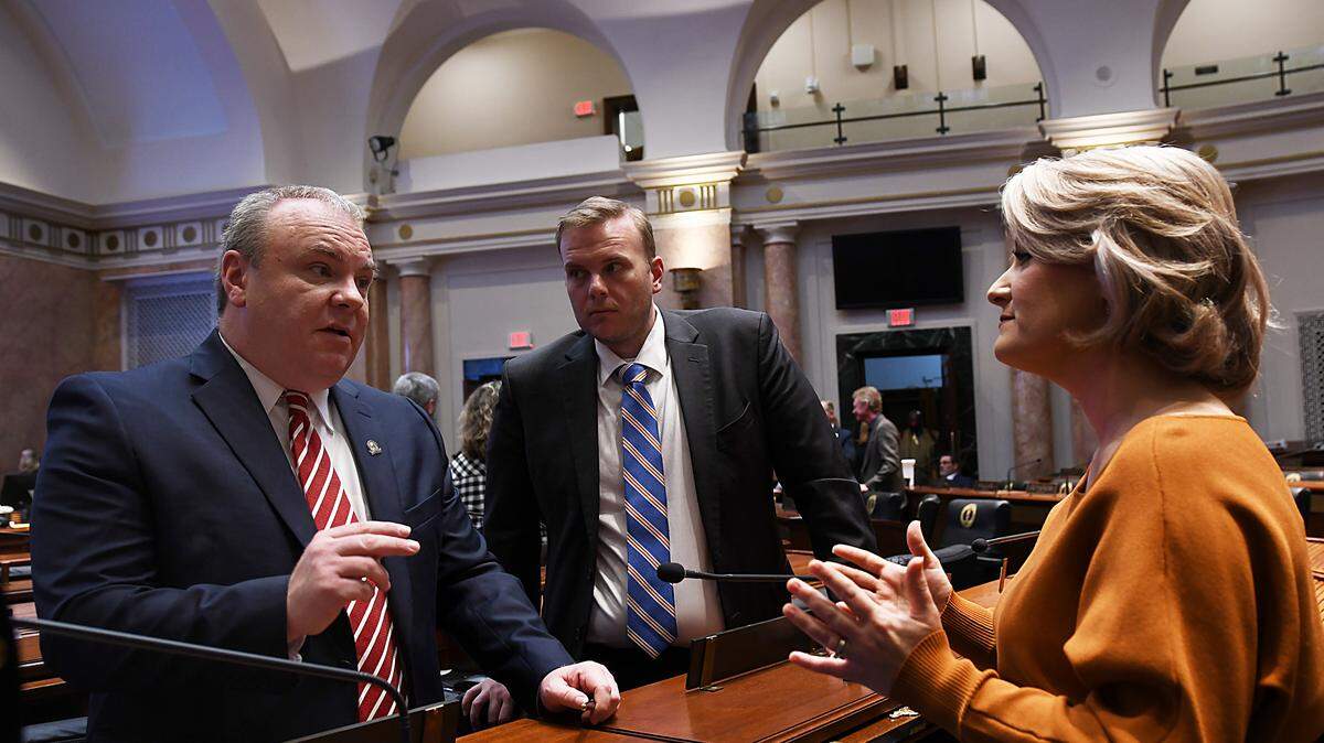 House Majority Whip Jason Nemes, R-Middletown, Rep. Steven Doan, R-Erlanger, and Rep. Savannah Maddox, R-Dry Ridge discuss a bill on the House floor.