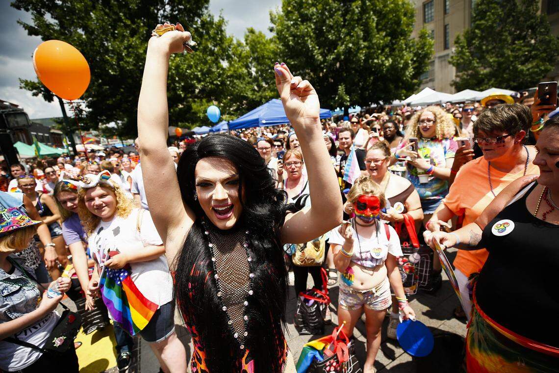 Miss Lexington Pride Cortney Carson, of Louisville, center, dances with the crowd during the afternoon drag show during Lexington Pride Festival 2018 Saturday at courthouse plaza in Lexington.