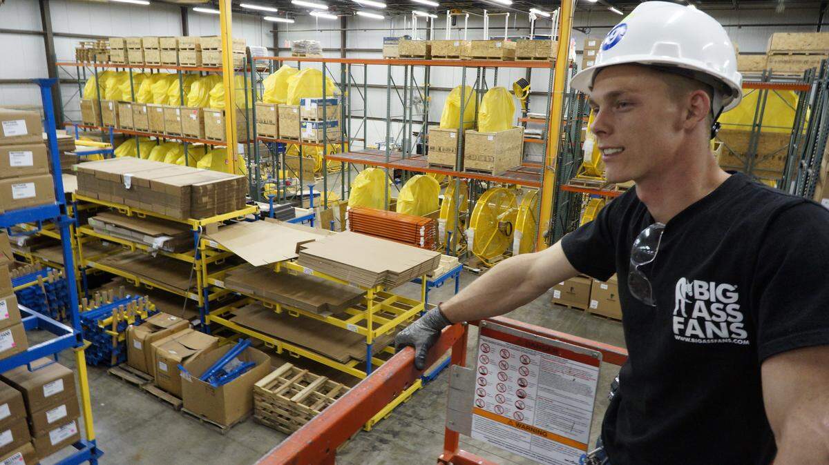 Brian Watson operates a sky lift in the warehouse on Wednesday, March 28, 2012 at Big Ass Fans on 2425 Merchant St. in Lexington, Ky.  Eight-foot diameter floor fans are warehoused in the back row. Photo by David Perry | Staff