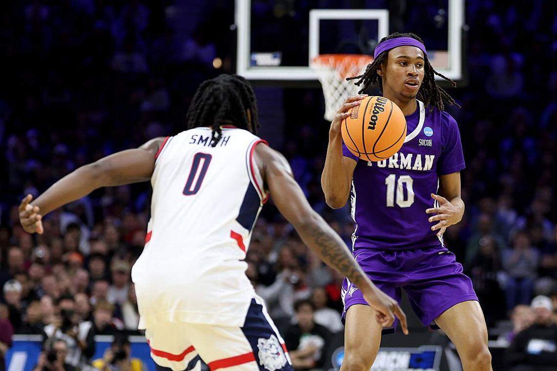 PHILADELPHIA, PENNSYLVANIA - MARCH 20: Malachi Smith #0 of the UConn Huskies defends Alex Wilkins #10 of the Furman Paladins during the first half in the first round of the 2026 NCAA Men's Basketball Tournament at Xfinity Mobile Arena on March 20, 2026 in Philadelphia, Pennsylvania. (Photo by Emilee Chinn/Getty Images)