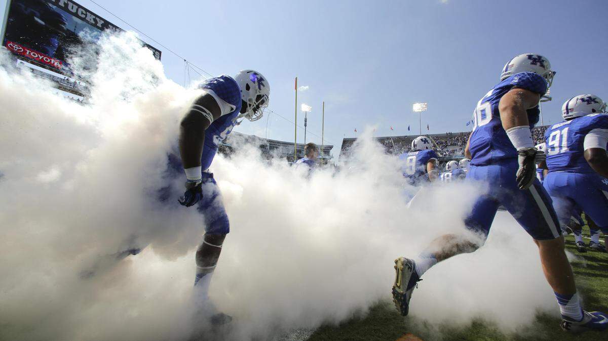 Emerging from a wall of smoke with a few Air Raid sirens thrown in, the Kentucky football team ushered in the Mark Stoops era in Lexington. The Cats gave Stoops his first win as a head coach by beating ­Miami (Ohio), 41-7 in 2013.