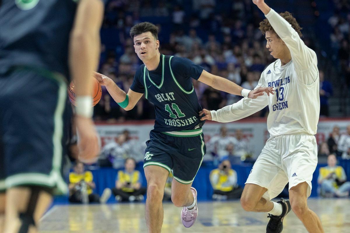 Great Crossing’s Gage Richardson (11) drives the ball as Bowling Green’s Joseph Hurt (13) defends during the UK Healthcare Boys’ Basketball Sweet 16 state tournament championship game at Rupp Arena on Saturday.