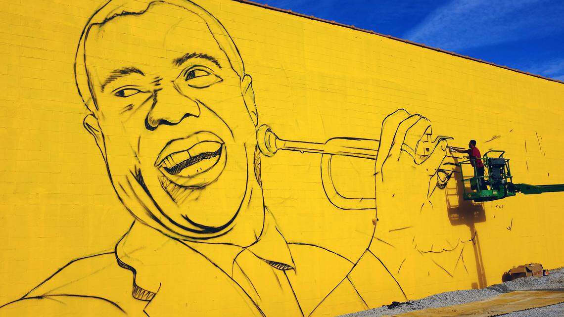 Sergio Odeith, a Portuguese mural artist, began work Monday on a 30-by-70-foot mural of jazz great Louis Armstrong and his trumpet on the side of Lighthouse Ministries, 185 Elm Tree Lane. Photo by Tom Eblen | teblen@herald-leader.com