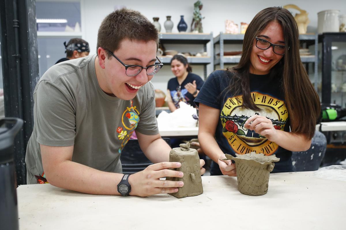 Matt McBee, 17, of Fort Mitchell, Ky., left, and, Camille Moore, 17, of Owensboro, Ky., laugh with other students during a ceramics class during the Governor’s School for the Arts at the University of Kentucky School of Art & Visual Studies in Lexington, Ky., Friday, June 28, 2019. Students were participating in “smorgs” on Friday which gives them a class outside of their artistic discipline.