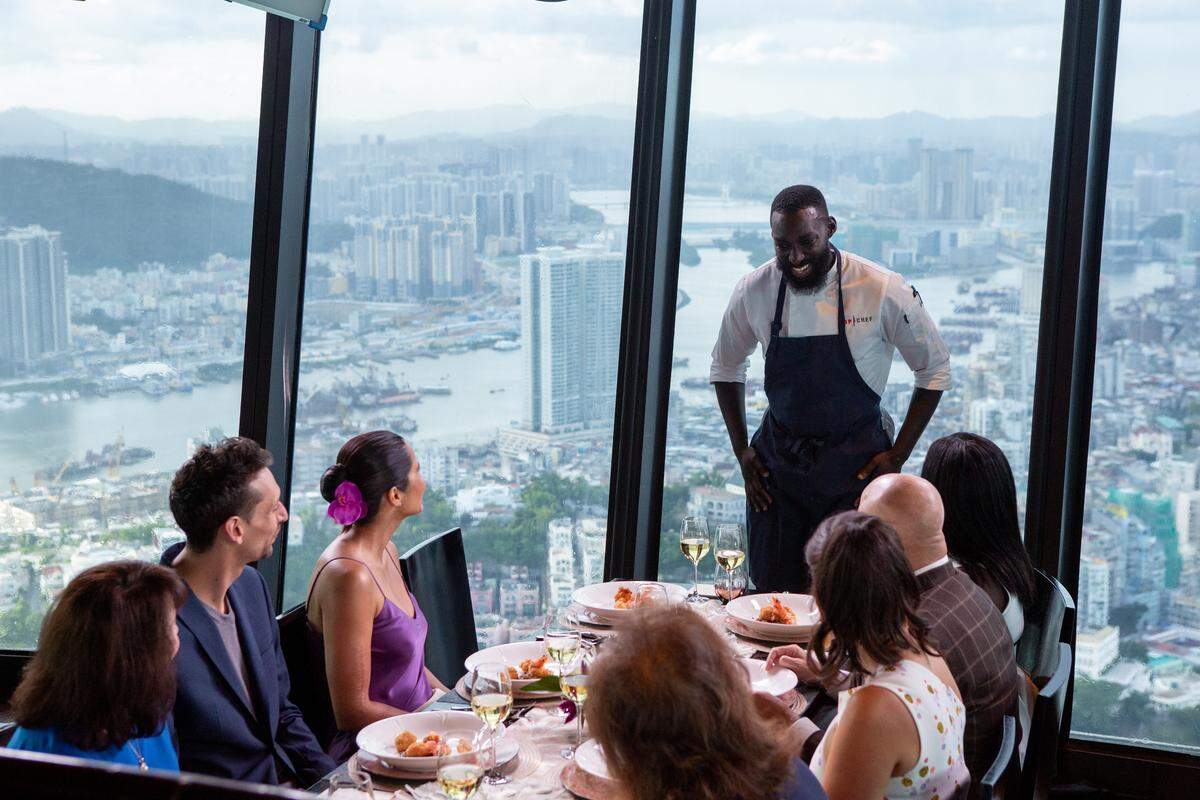 That skyline! Chef Eric Adjepong tells the judges, including guest judge Abe Conlon, host Padma Lakshmi and head judge Tom Colicchio about his dish.