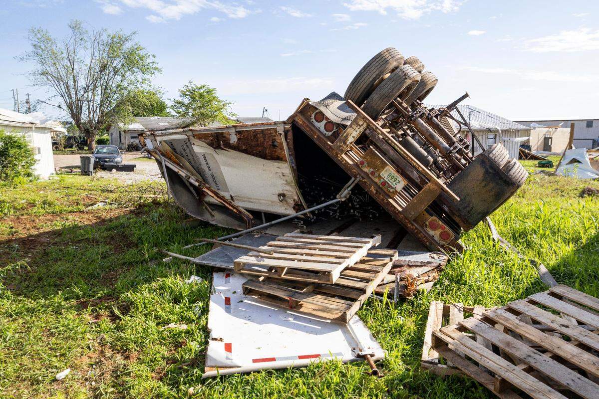 A truck is flipped on its side on Sunday, May 18, 2025, behind Mattress Overstock off U.S. Route 27 in Somerset, Ky.