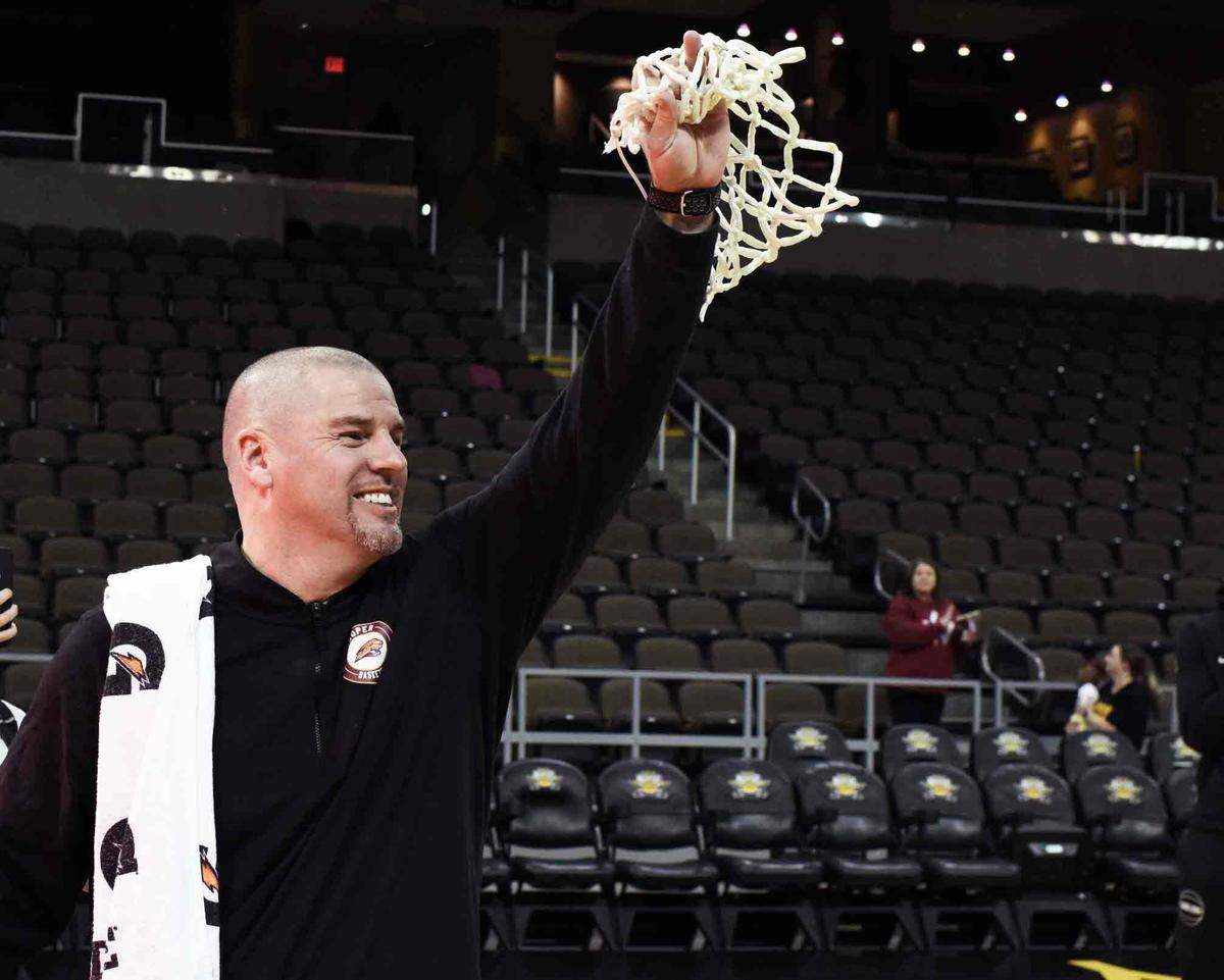 Head coach Tim Sullivan raised the net and displayed it for supporters after Cooper won the Ninth Region championship last week.
