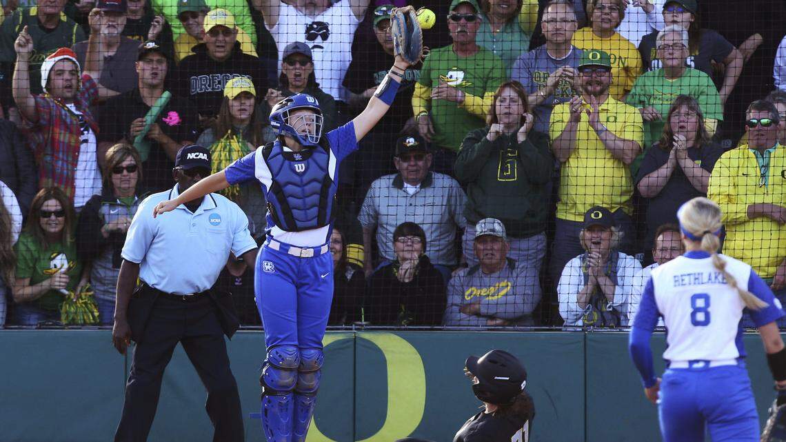 Kentucky catcher Jenny Schaper, left, couldn't make the play as Oregon's Gwen Svekis slid in for a run during the second inning of the Ducks' series-clinching win in the Eugene Super Regional on Saturday.
