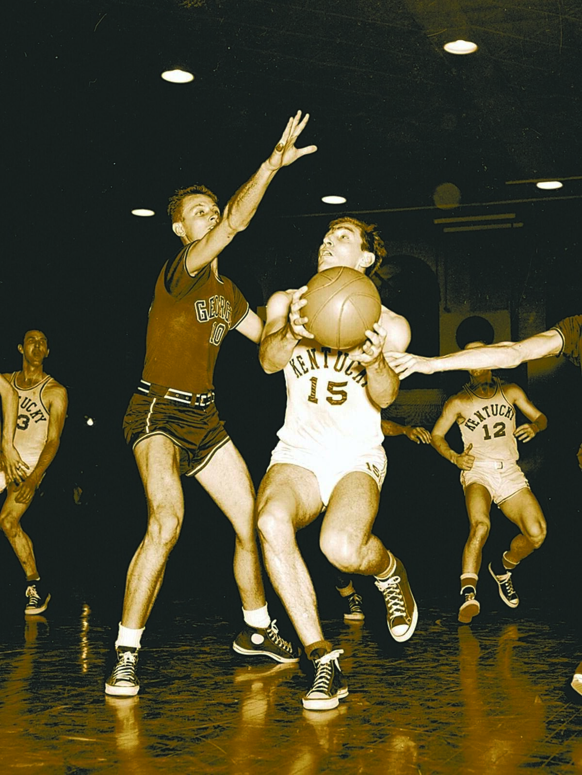 1949 FILE PHOTO: University of Kentucky's Alex Groza, right, goes by University of Georgia's Al Fabian, on his way to two points in Alumni Gymnasium on February 21, 1949. Groza set an SEC scoring record when he reached 38 points as UK defeated Georgia 95-40.