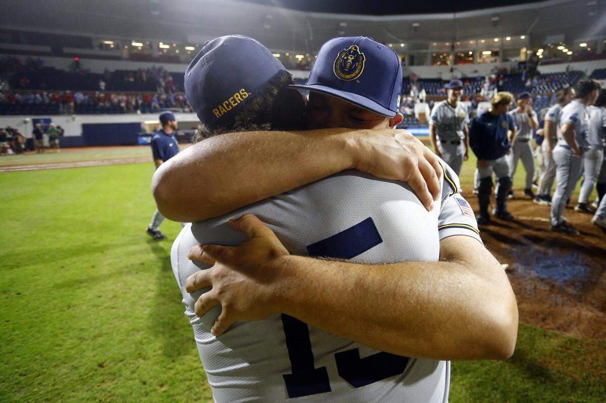 Murray State head coach Dan Skirka embraces outfielder Jonathan Hogart (15) after the Racers defeated Ole Miss in the Oxford Regional on Monday.