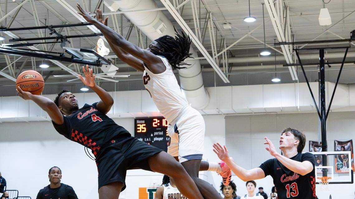 GRC's JaMylyn Johnson (4) is fouled while going for a lay up by Douglass's Thurman Wade (0) during the George Rogers Clark vs Frederick Douglass basketball game on Jan. 10, 2026, in Lexington, Ky.