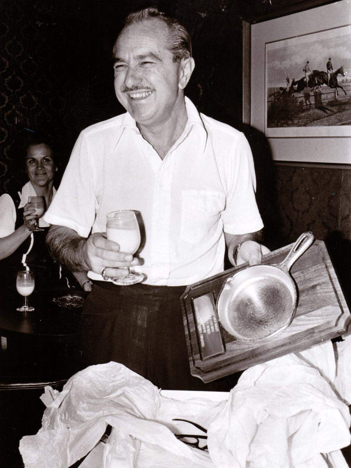 Lexington restaurant owner Stanley Demos held a 24-carat gold frying pan given to him by his employees at The Coach House for Christmas in December 1975.
