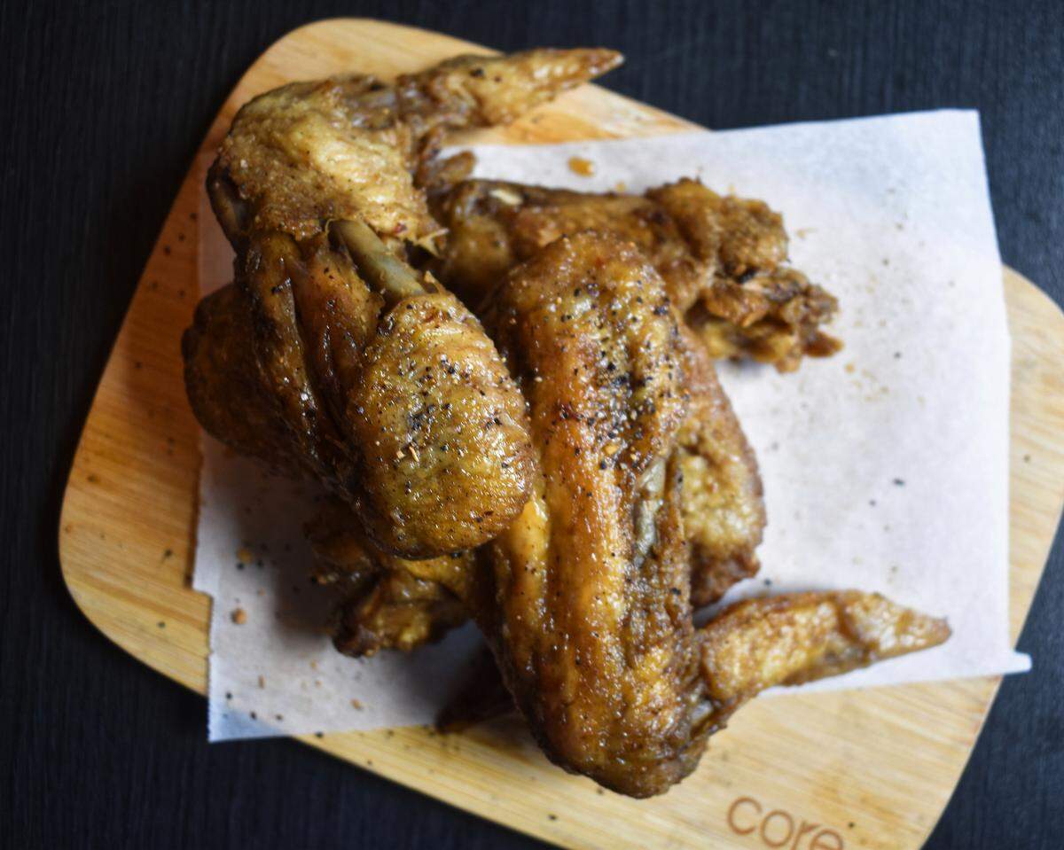 Jerk chicken wings are among the small plates on offer at Beach House Caribbean Coffee & Tapas on W. Sixth Street.