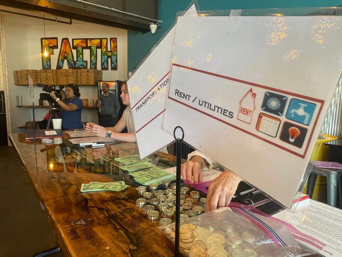 Different tables inside DV8 Kitchen were set up as places people needed to go as part of a reentry simulation on Thursday night.