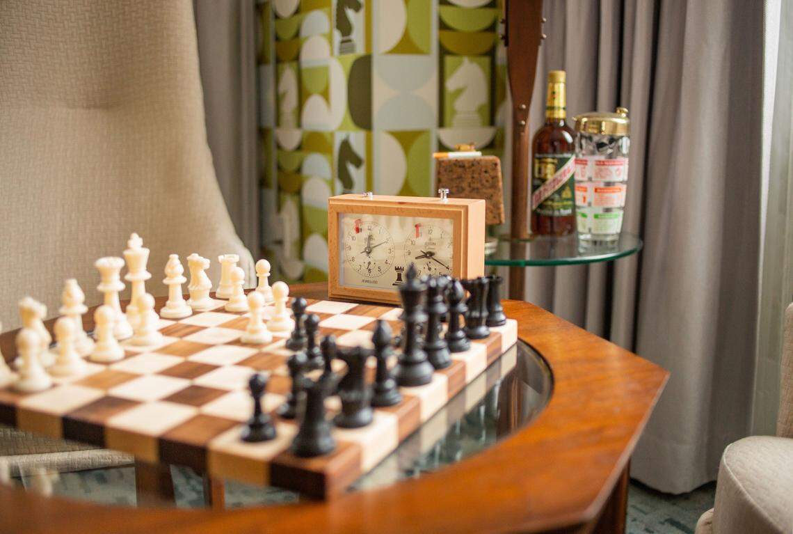 The Harmon Room features a vintage chess set as well as period-appropriate accessories, including the makings for cocktails.