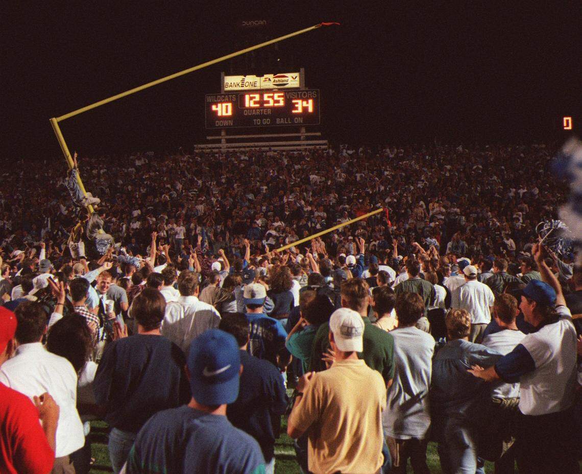 UK fans storm the field and tear down a goal post at Commonwealth Stadium after the Wildcats beat Alabama 40-34 in overtime in 1997.