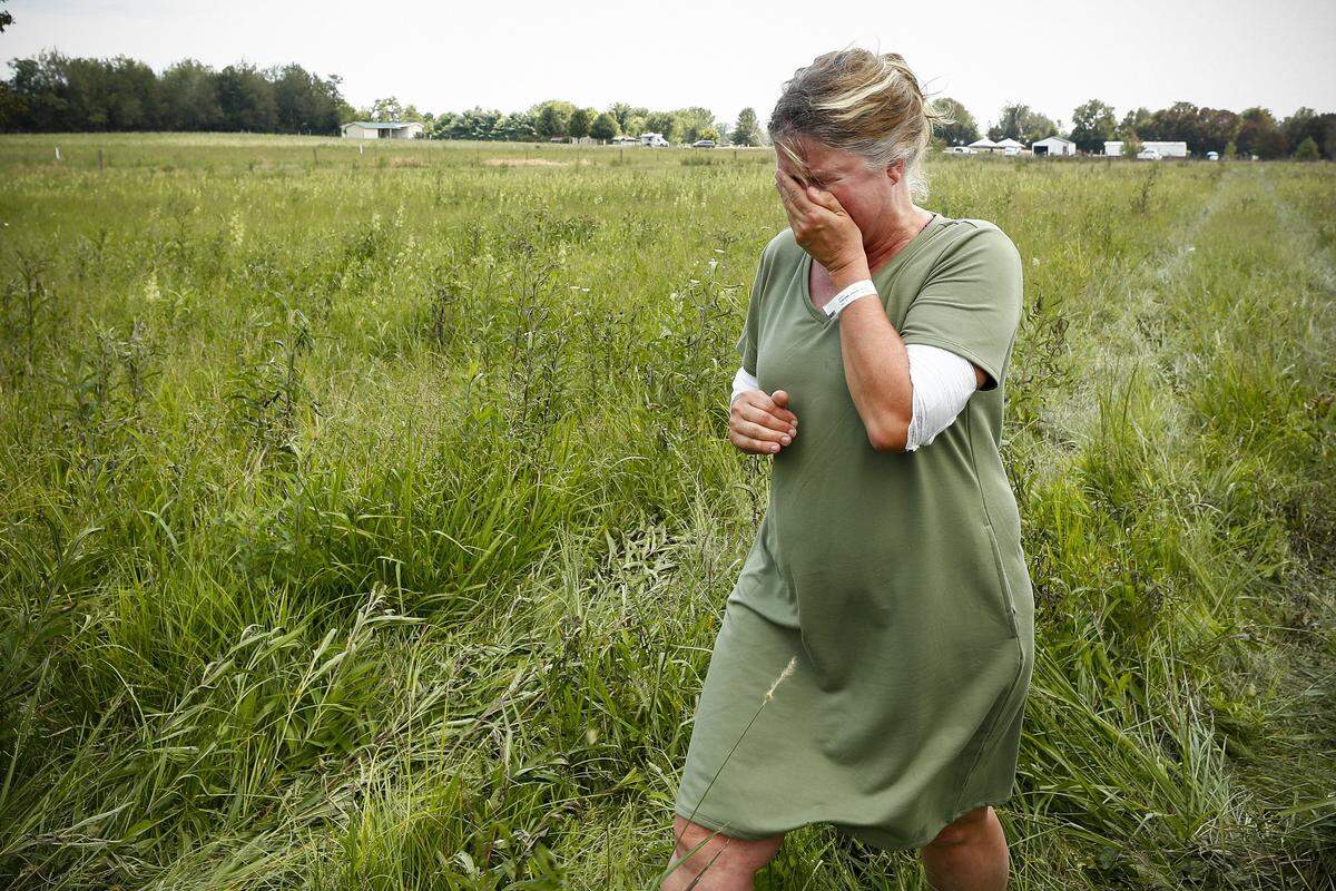 Jodie Coulter, of Moreland, was overcome with emotion near the site of her home that was destroyed in a gas line explosion Thursday, Aug. 1, 2019. She was burned escaping the blast and fire. Coulter also lost her belongings.