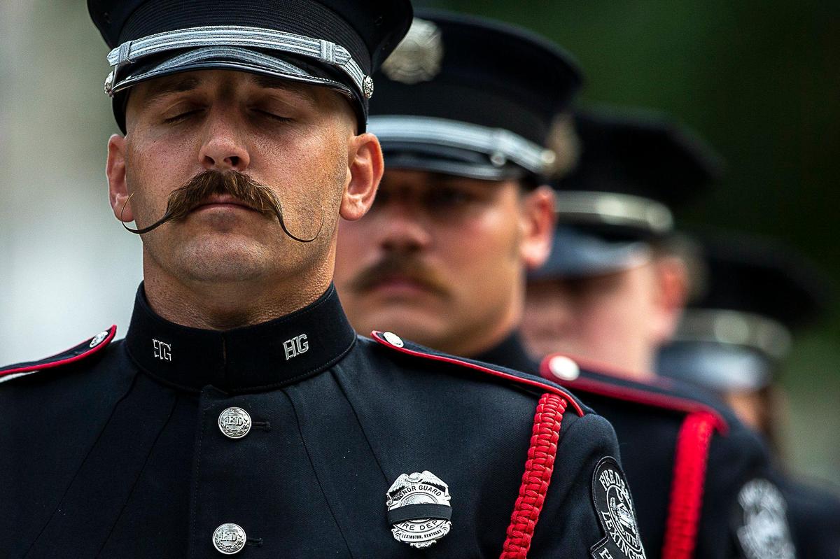 Firefighter Joe Appleget leads members of the Lexington Fire Department’s Honor Guard as they prepare to raise the U.S. flag during a wreath-laying service Wednesday, Sept. 11, 2019, at Lexington’s Phoenix Park to commemorate first responders killed in the 9/11 attack in 2001.