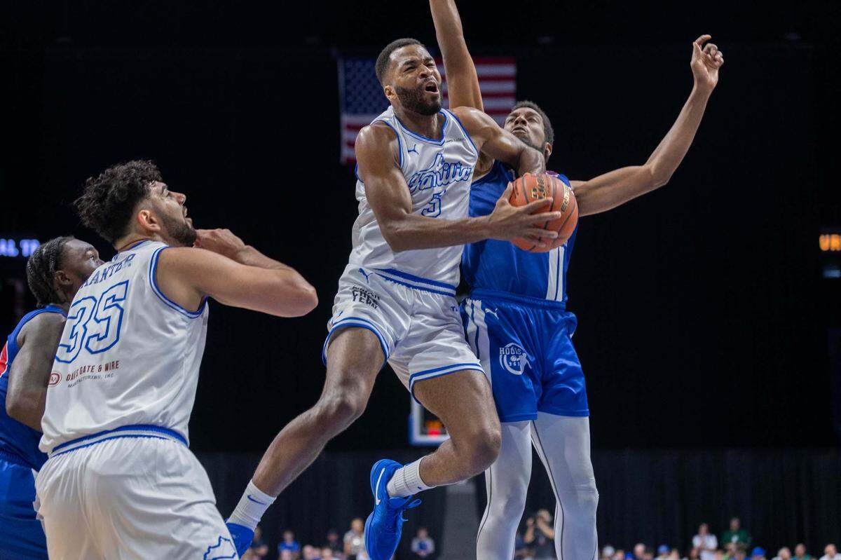 La Familia player Andrew Harrison draws contact while attempting a shot during Sunday’s game against The Nawf during the TBT at Rupp Arena.