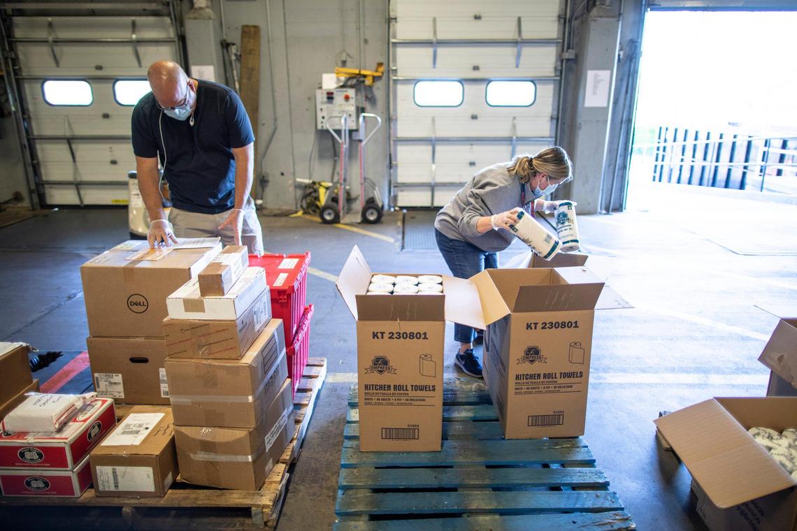 Steve Hill, left, Fayette County Public Schools director of pupil personnel, and Tammy Hopkins, assistant director of pupil personnel, prepared supplies for Family Resource Center directors at a Fayette County Public Schools warehouse in Lexington. The supplies were then distributed to students’ families.