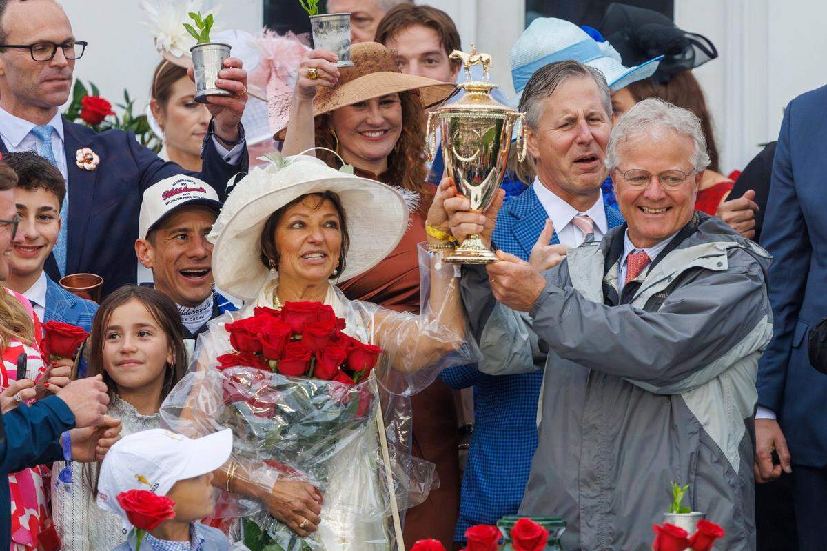 Winning Trainer Bill Mott hoists the trophy after Sovereignty prevailed in the 151st Kentucky Derby.
